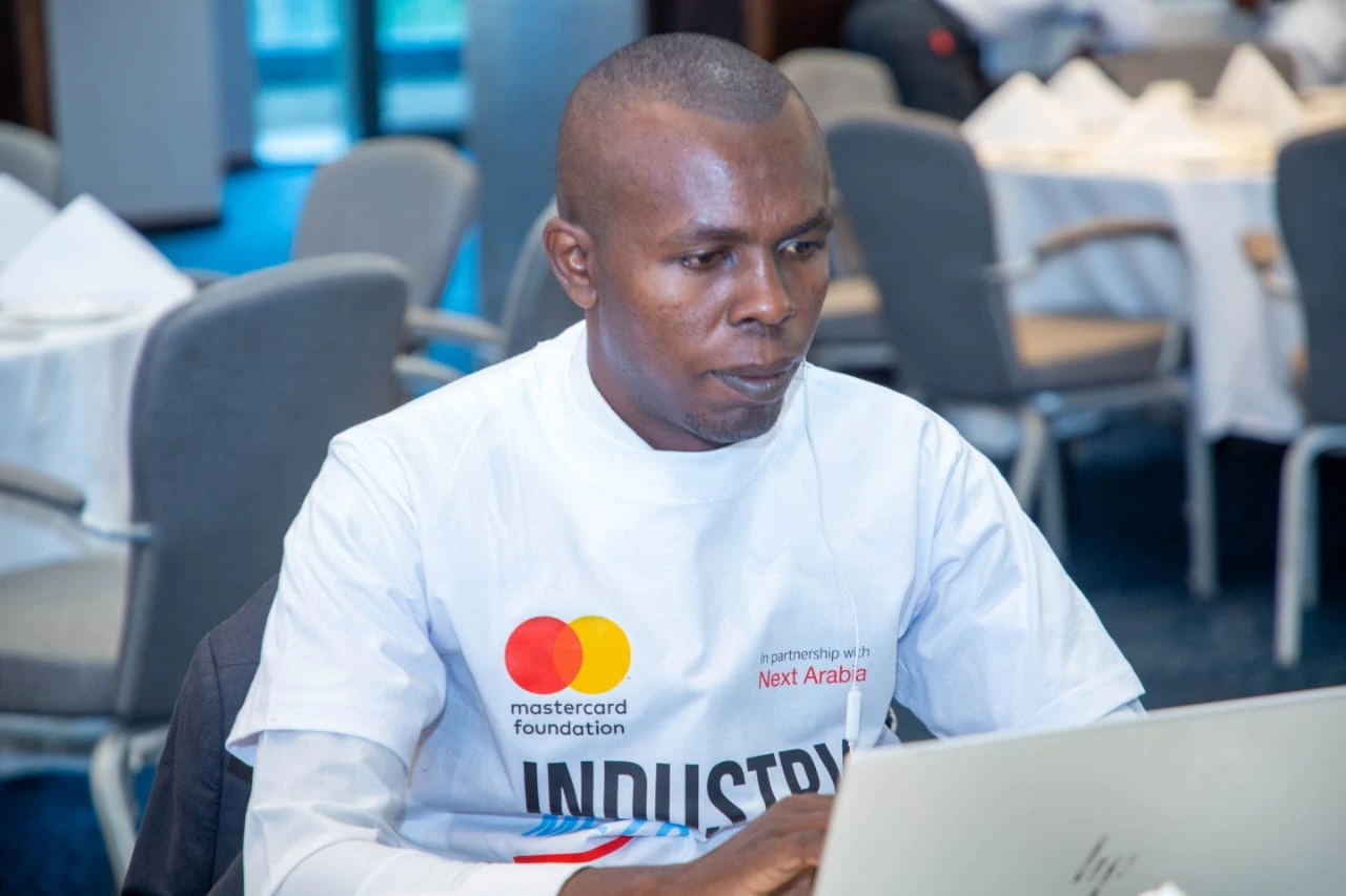 Nicolous Njoroge working at a laptop